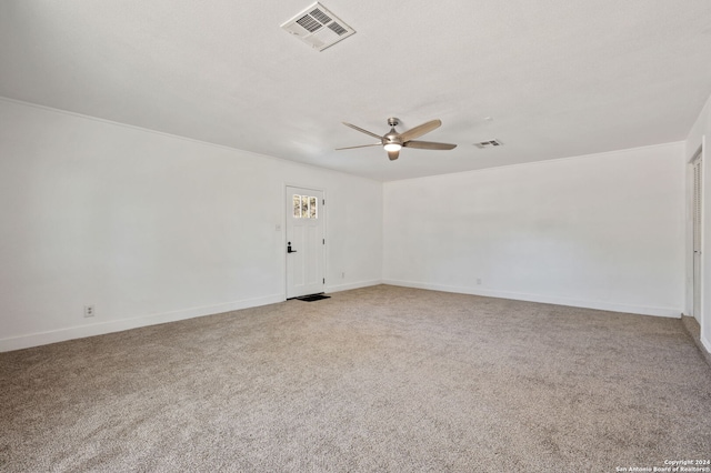 carpeted empty room featuring ceiling fan