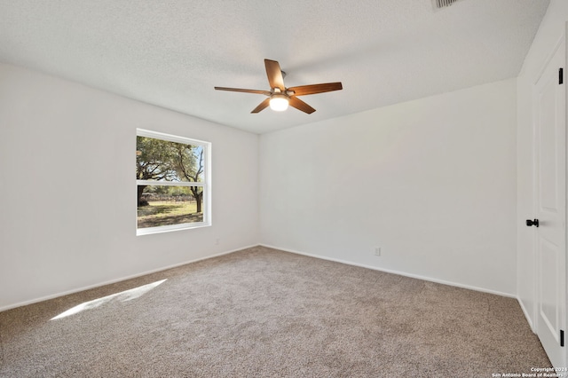 carpeted spare room featuring a textured ceiling