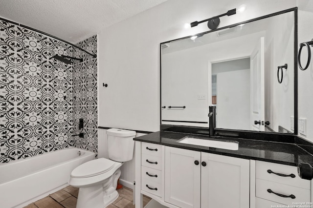 full bathroom featuring hardwood / wood-style floors, vanity,  shower combination, toilet, and a textured ceiling