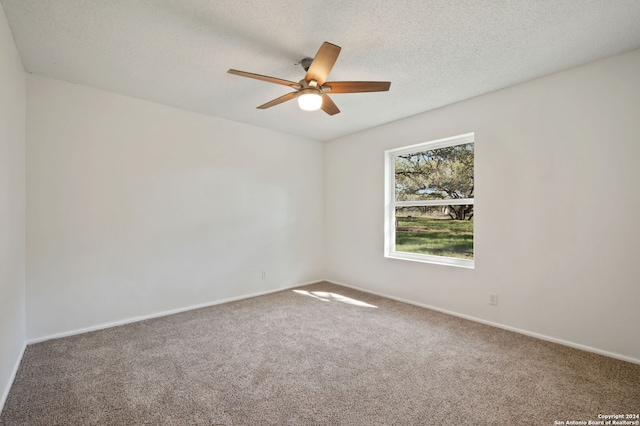 carpeted empty room featuring a textured ceiling and ceiling fan