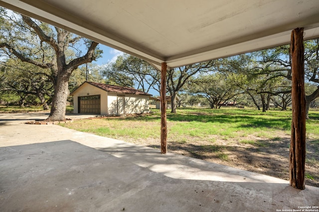 view of patio / terrace with an outdoor structure and a garage