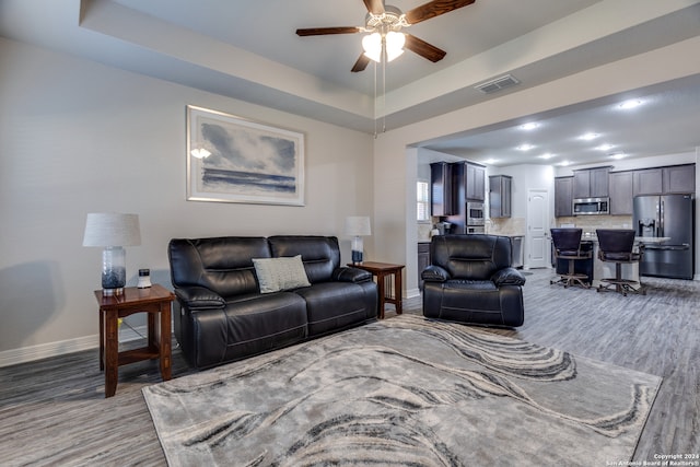 living room with ceiling fan and hardwood / wood-style floors