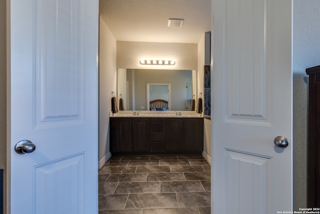 bathroom featuring vanity and a textured ceiling