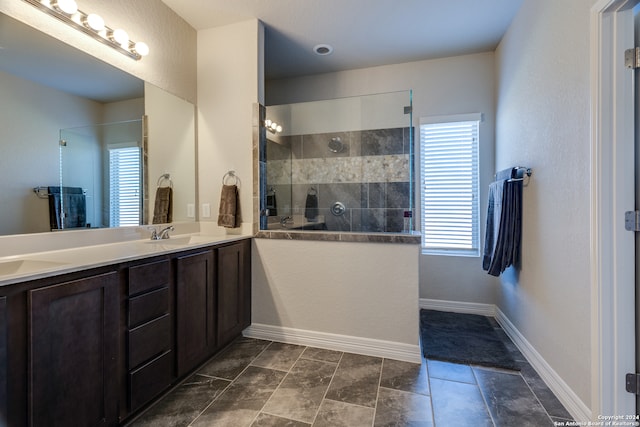 bathroom with vanity and tiled shower