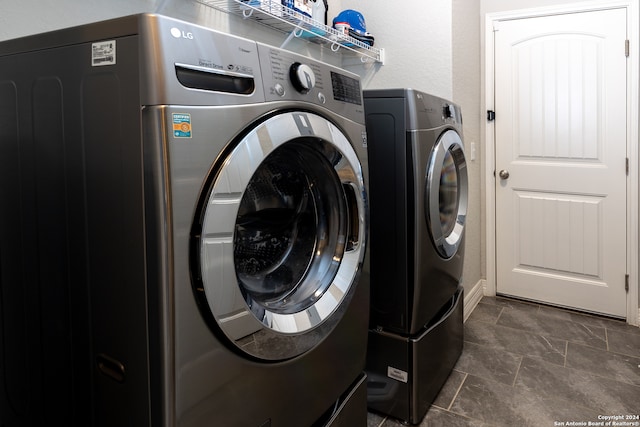 clothes washing area with washing machine and clothes dryer