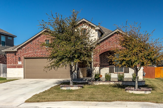 front facade featuring a garage and a front lawn