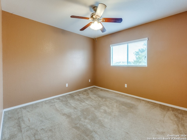 unfurnished room with ceiling fan and carpet floors