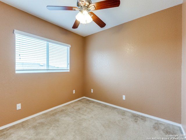 unfurnished room featuring ceiling fan and light carpet