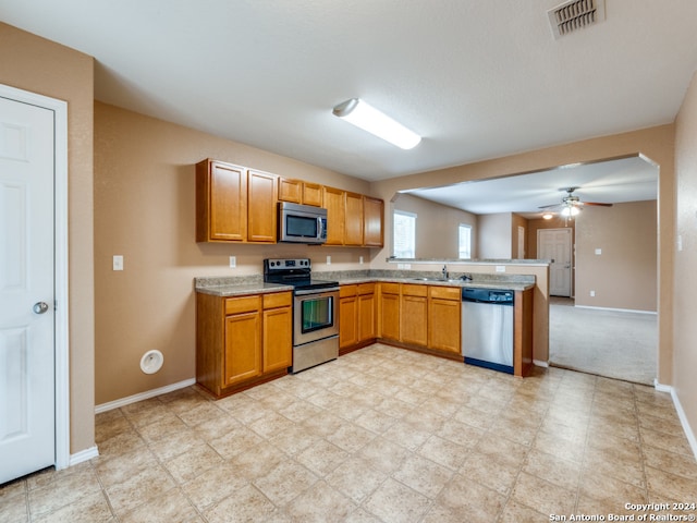 kitchen with ceiling fan, sink, and appliances with stainless steel finishes