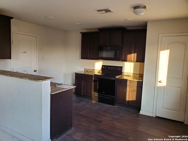 kitchen featuring dark brown cabinets, dark hardwood / wood-style flooring, light stone counters, and black appliances