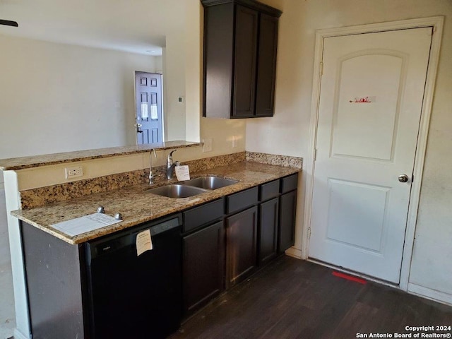 kitchen featuring sink, light stone countertops, black dishwasher, dark brown cabinets, and dark hardwood / wood-style flooring