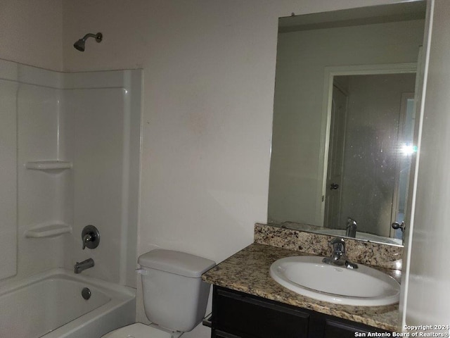 full bathroom featuring toilet, vanity, and washtub / shower combination