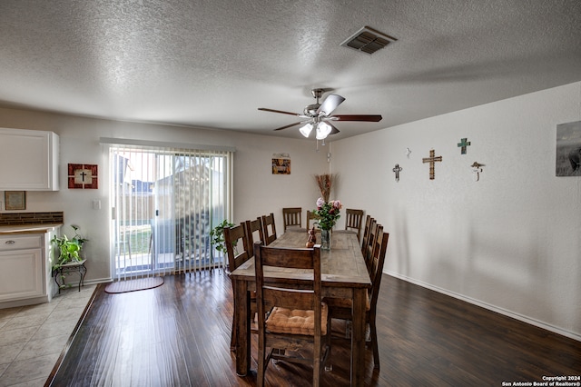 dining room featuring a textured ceiling, light hardwood / wood-style floors, and ceiling fan