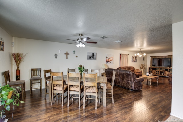 dining space with ceiling fan with notable chandelier, dark hardwood / wood-style flooring, and a textured ceiling