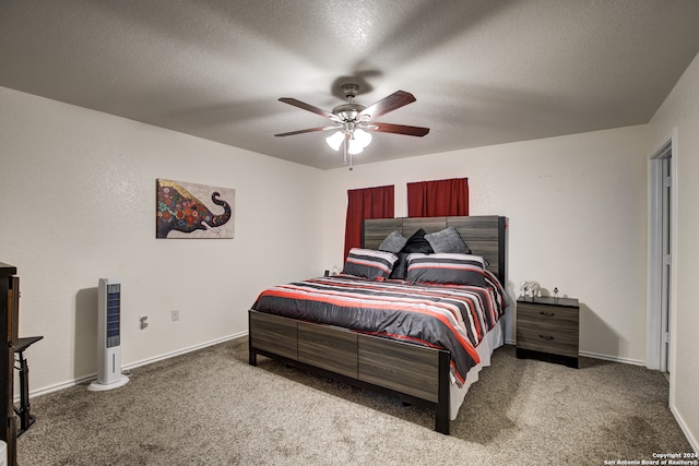 bedroom with carpet flooring, ceiling fan, and a textured ceiling