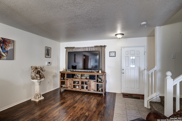 foyer featuring hardwood / wood-style flooring and a textured ceiling