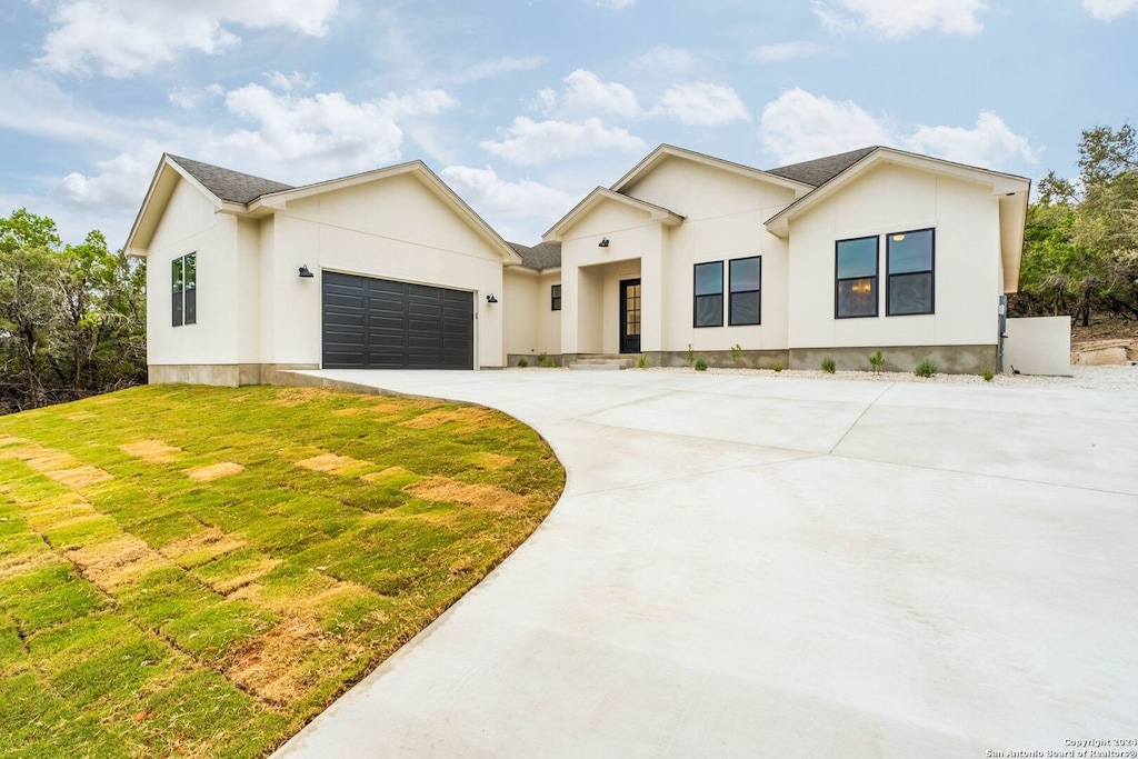 view of front of property with a front yard and a garage