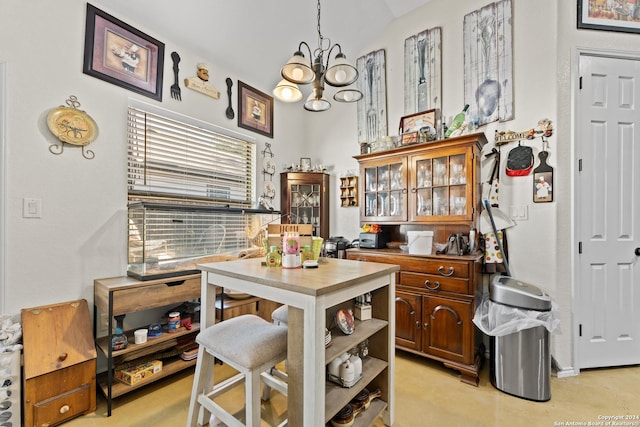 kitchen featuring a chandelier, vaulted ceiling, and hanging light fixtures