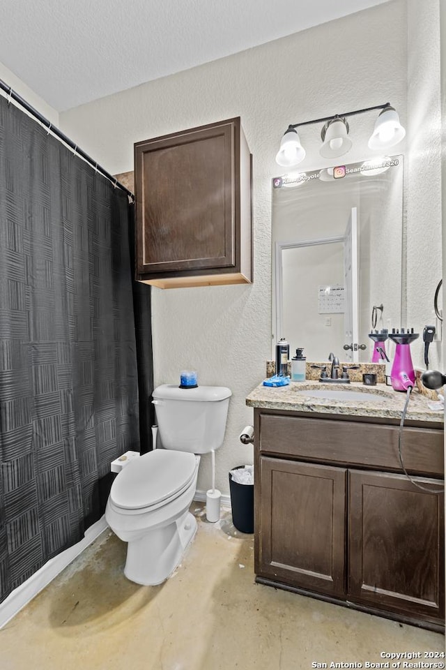 bathroom with vanity, concrete flooring, a textured ceiling, and toilet