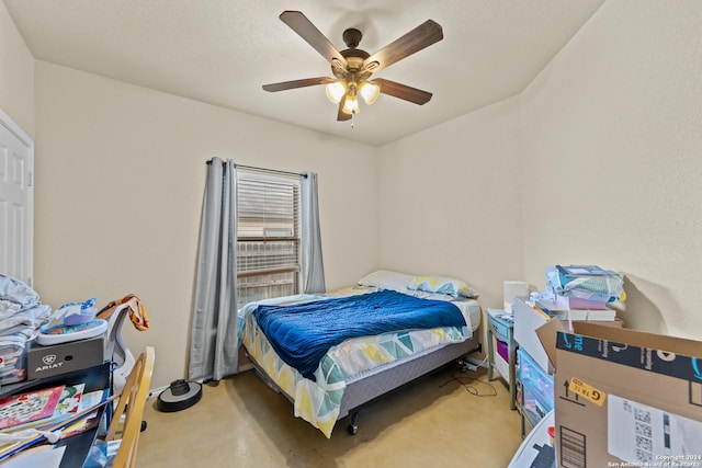 carpeted bedroom featuring a textured ceiling and ceiling fan