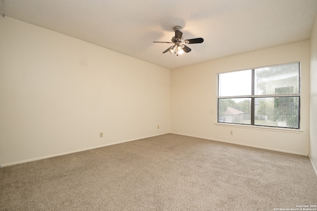 empty room with carpet, a textured ceiling, and ceiling fan