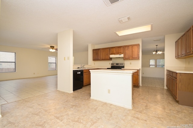 kitchen with a wealth of natural light, dishwasher, pendant lighting, and sink