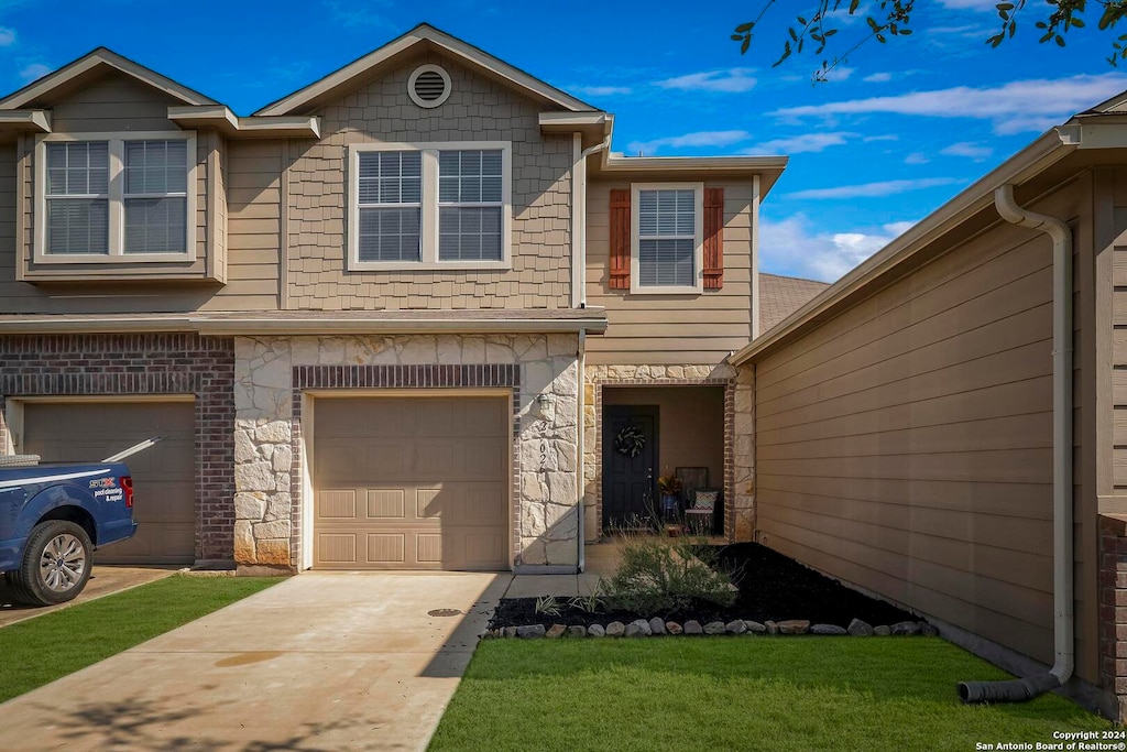 view of front of house with a front yard and a garage