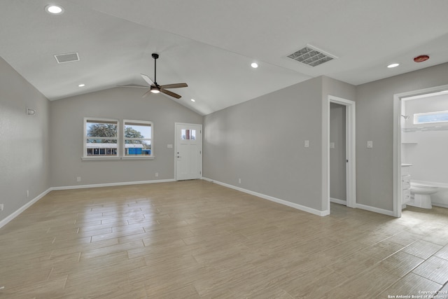 unfurnished living room with ceiling fan, vaulted ceiling, and light wood-type flooring