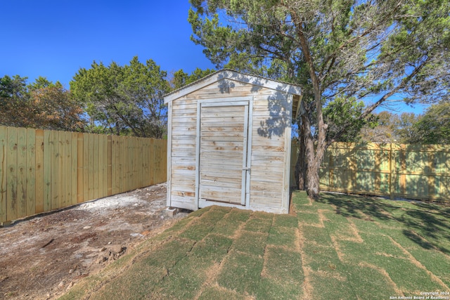 view of outbuilding featuring a yard