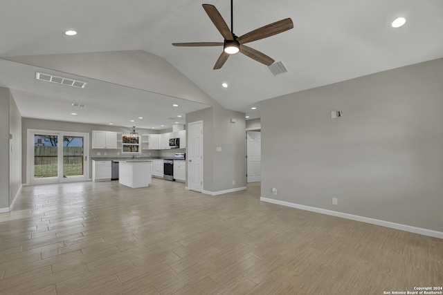 unfurnished living room featuring light hardwood / wood-style floors, ceiling fan, lofted ceiling, and sink