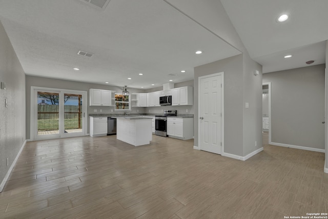 kitchen featuring a center island, white cabinets, stainless steel appliances, and light hardwood / wood-style flooring