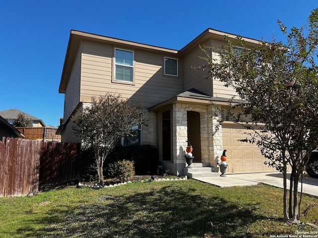 view of front of home with a garage and a front yard