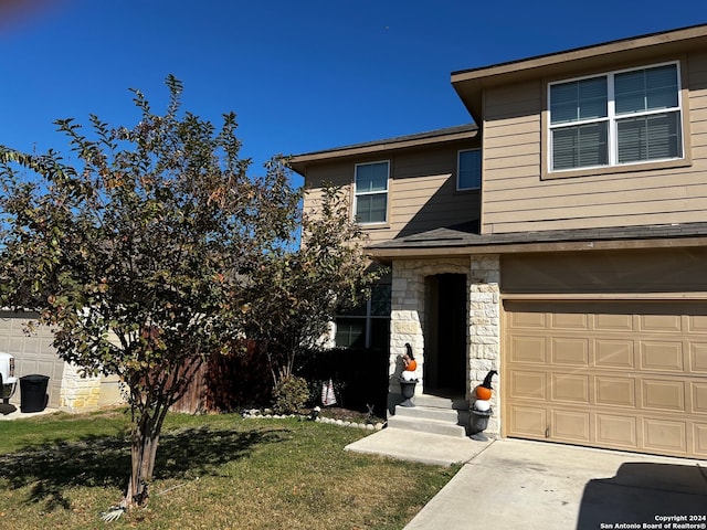 view of front of property featuring a garage and a front lawn