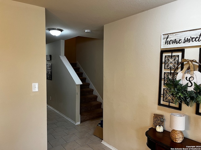 stairway with tile patterned flooring