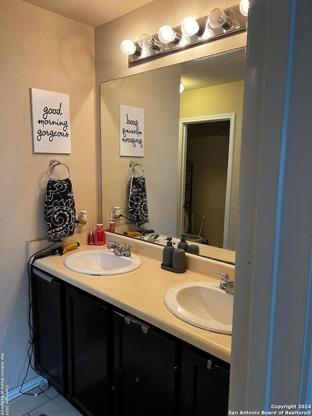 bathroom featuring tile patterned flooring and vanity