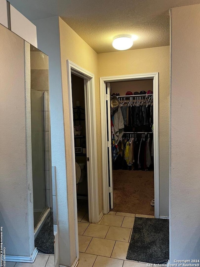 bathroom featuring tile patterned floors and a textured ceiling