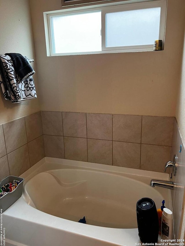 bathroom with a tub to relax in