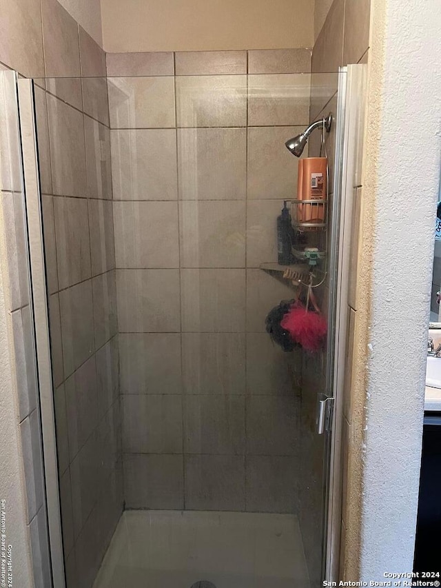 bathroom with a shower with shower door