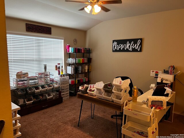 home office featuring carpet, vaulted ceiling, and ceiling fan