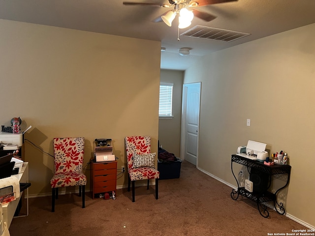 sitting room featuring carpet and ceiling fan