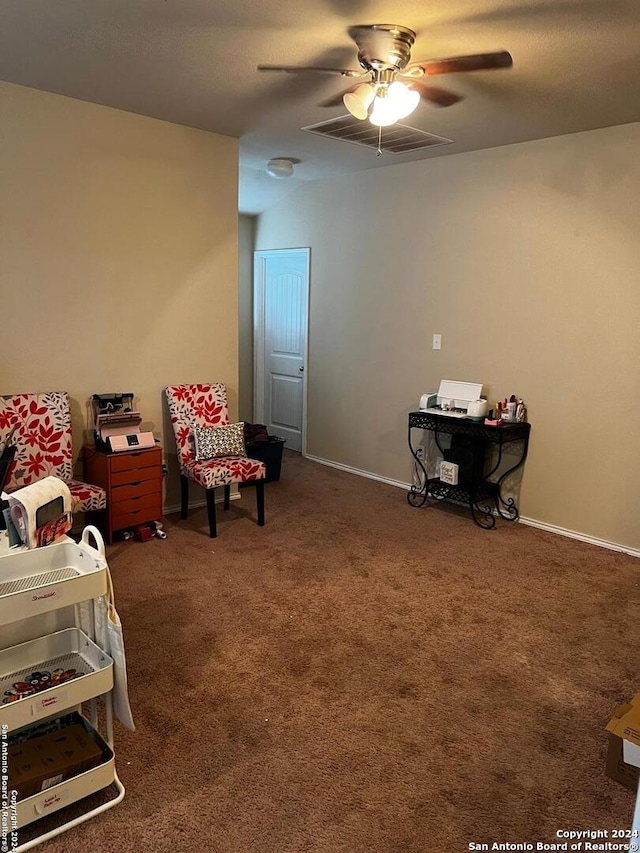 living area with dark colored carpet and ceiling fan