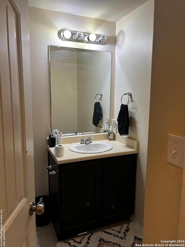 bathroom with tile patterned flooring and vanity