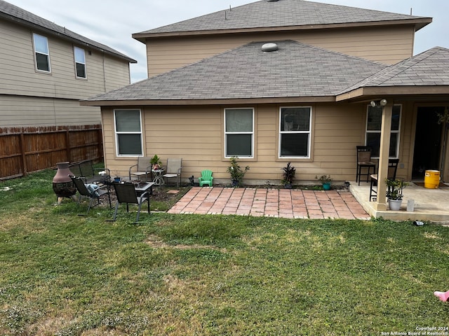 back of property featuring a yard and a patio