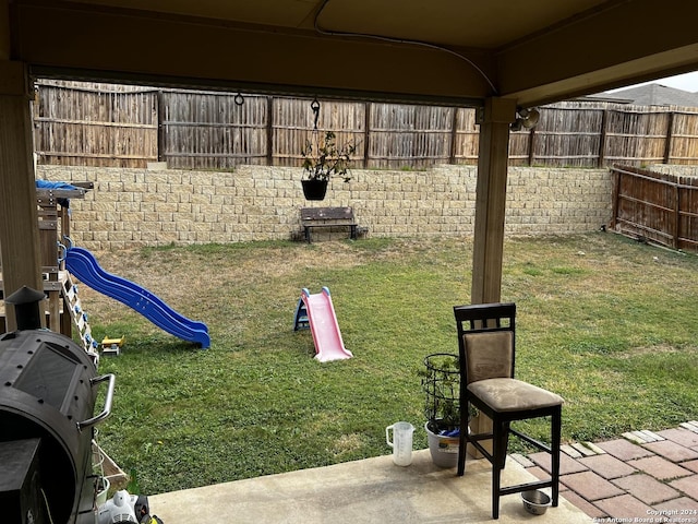 view of yard featuring a patio and a playground