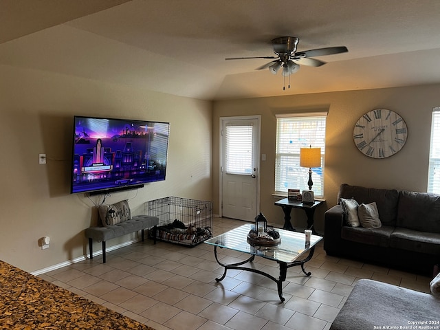 living room with tile patterned floors, ceiling fan, and lofted ceiling