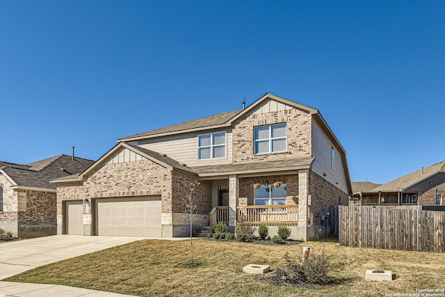 craftsman-style home with covered porch, a garage, and a front yard