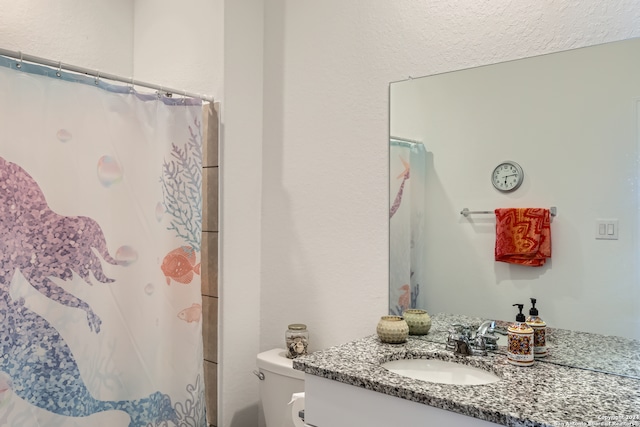 bathroom with a shower with shower curtain, vanity, and toilet