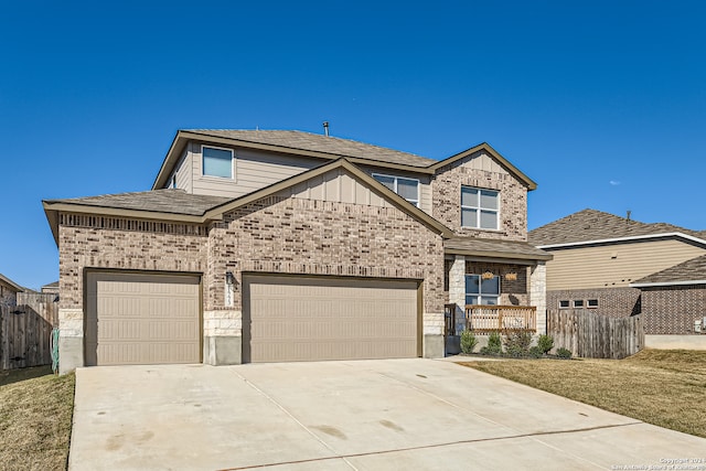 view of front of home featuring a front yard and a garage