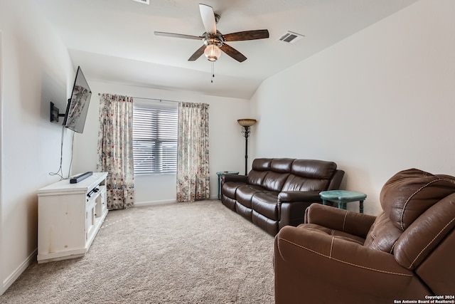 living room featuring ceiling fan, light colored carpet, and vaulted ceiling