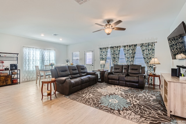 living room featuring ceiling fan and hardwood / wood-style floors